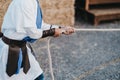 Closeup shot of a male in traditional suit pulling a thick rope Royalty Free Stock Photo