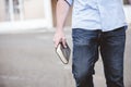 Closeup shot of a male walking while holding the bible Royalty Free Stock Photo