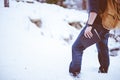 Closeup shot of a male wearing a backpack standing in the snow and holding the bible Royalty Free Stock Photo