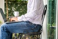 Closeup shot of a male working on his laptop - posture ergonomics concept