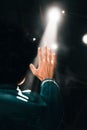 Closeup shot of a man, blocking the reflector light with a raised hand