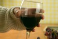 Closeup shot of a man holding a glass of red wine on a blurred background Royalty Free Stock Photo