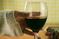 Closeup shot of a man holding a glass of red wine on a blurred background Royalty Free Stock Photo