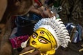 Closeup shot of a man painting the face of Goddess Durga in preparations for the Durga Puja festival