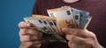 Closeup shot of a man's hand holding euro bills Royalty Free Stock Photo