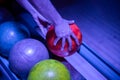 Closeup shot of a man's hand picking up a bowling ball Royalty Free Stock Photo
