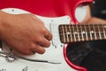 Closeup shot of a man's hand playing electric guitar against black background Royalty Free Stock Photo