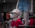 Closeup shot of a mannequins in a clothing boutique with a blur background of clothes