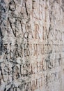 Closeup shot of many Latin capital letters engraved on a stone