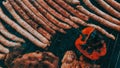 Closeup shot of many sausages and vegetables on a barbeque brazier