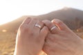 Closeup shot of a married couple hands with silver wedding rings on a sunny day Royalty Free Stock Photo