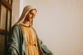 Closeup Shot Of A Mary, Mother Of Jesus Statue Against A White Wall