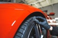 closeup shot of a mechanic with black gloves cleaning a tire at the workshop