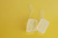 Closeup shot of melting ice cubes on a yellow background Royalty Free Stock Photo