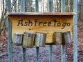 Closeup shot of metal cans as ashtrays stuck on a wooden board in a park against forest fires