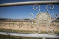 Closeup shot of a metal fence detail with Spanish writings