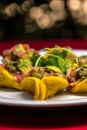 Closeup shot of Mexican-style tacos on a white plate, filled with minced meat Royalty Free Stock Photo