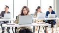 Closeup shot of millennial Asian young stressed depressed sleepy female businesswoman employee sitting holding hand on messy hair Royalty Free Stock Photo