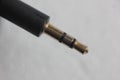 Closeup shot of a mini-jack of a lapel microphone on a white background Royalty Free Stock Photo