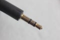 Closeup shot of a mini-jack of a lapel microphone on a white background Royalty Free Stock Photo