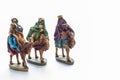 Closeup shot of miniatures of three wise men on a camel isolated on white background Royalty Free Stock Photo