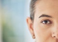 Closeup shot of a mixed race woman, half faced, with a nose piercing looking straight at the camera. Beautiful young Royalty Free Stock Photo