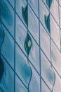 Closeup shot of a modern glass building with wavy blue window shapes Royalty Free Stock Photo