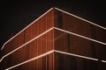 Closeup shot of a modern wooden building with lights on in Poland, Wroclaw