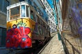 Closeup shot of a multicolored wagon on a railway surrounded by buildings