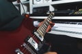 closeup shot of a musician playing a bass guitar in a studio, music concept Royalty Free Stock Photo