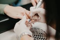 Closeup shot of the nail master removing a shellac from the client's nails Royalty Free Stock Photo