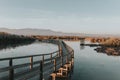 Closeup shot of a narrow bridge dock above the lake at sunset Royalty Free Stock Photo