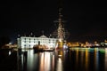 Closeup shot of the National Maritime Museum of Amsterdam at night surrounded with colorful lights Royalty Free Stock Photo