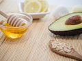 Closeup shot of natural skincare product ingredients: avocado, honey, oat flakes, and lemon