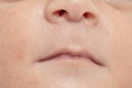 Closeup shot of a newborn baby lip and nose- peacefully slept in bed