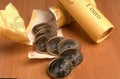 Closeup shot of newly opened packs of 1 euro coins placed on a wooden surface Royalty Free Stock Photo