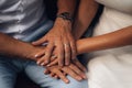 Closeup shot of newlyweds holding hands, wearing matching wedding bands.