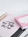 Closeup shot of a notebook with a writing "enjoy the little things"