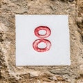 Closeup shot of number eight, stone wall Royalty Free Stock Photo