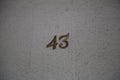 Closeup shot of number forty-three on a wall of the house Royalty Free Stock Photo