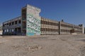 Closeup shot of an old abandoned building painted with graffiti under the blue sky