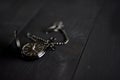 Closeup shot of an old black pocket watch on a black wooden surface with a blurred background Royalty Free Stock Photo