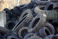 Closeup shot of old car tires dumped in a field during daytime Royalty Free Stock Photo