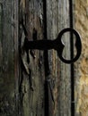 Closeup shot of an old door key in a keyhole of an old door Royalty Free Stock Photo