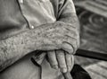 Closeup shot of an old males hands with a walking stic