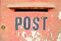 Closeup shot of an old red rusty post box