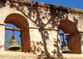 Closeup shot of old rusted mission bells handing on wooden rods