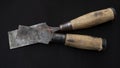 Closeup shot of old rusty chisels with wooden handles isolated on a black background Royalty Free Stock Photo