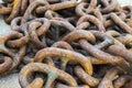 Closeup shot of an old rusty ship anchor chain laid on the ground Royalty Free Stock Photo