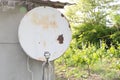 Closeup shot of an old satellite dish antenna in the garden Royalty Free Stock Photo